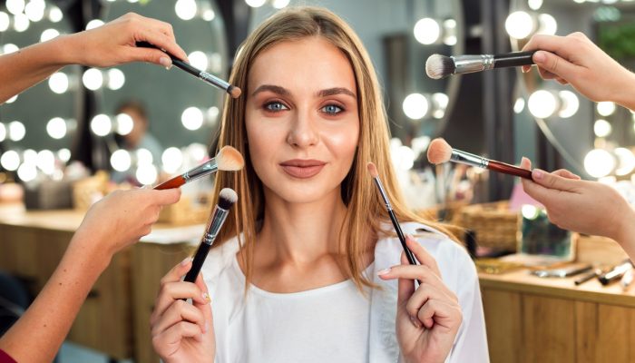 women-holding-make-up-brushes
